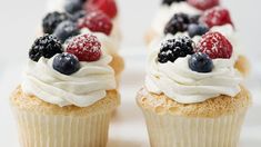 cupcakes with white frosting and berries on top