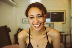 a smiling woman in a black tank top