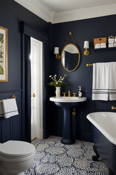 a white toilet sitting next to a bath tub under a bathroom mirror above a sink