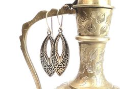 These exquisite gold Art Nouveau dangle earrings are a true testament to timeless elegance. Handcrafted with meticulous attention to detail, these earrings feature intricate embossed antique brass design, adorned with delicate gold accents. The design draws inspiration from the enchanting Egyptian motifs, adding a touch of exotic allure. They make a perfect gift for girlfriends, wife or mom. The drop length of these earrings is 1.5 inches, while the overall length is 2 inches. With a width of ju Antique Engraved Drop Earrings, Ornate Bronze Earrings, Vintage Brass Earrings With Engraving, Vintage Brass Earrings With Engraved Details, Vintage Engraved Brass Earrings, Ornate Nickel-free Bronze Jewelry, Bronze Ornate Nickel-free Jewelry, Engraved Teardrop Earrings For Gift, Ornate Bronze Drop Earrings