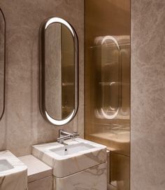 a bathroom with two sinks and mirrors in it