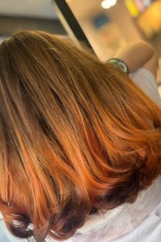 This hairstyle has a bold change of color, with a rich brown shade that changes into a bright orange at the ends like a fox, creating a cool but fun look. The hair is cut in long pieces with different lengths, allowing the two-tone effect to flow nicely, giving the style movement and depth. The gentle curls at the ends add a girly touch, - Click to see more of Get a Playful Edge: 33 Fox Hair Tips and Ideas and follow us for more hairstyle ideas. // Photo Credit: Instagram @hairbytinafitz Touch Of Color Hair, Orange Tipped Hair, Fox Dyed Hair Brown, Fox Tip Hair, Brown Hair Orange Tips, Orange Hair Tips, Red Ends Hair, Deep Orange Hair, Fox Tail Hair Color