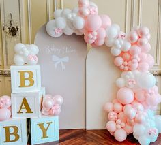 balloons and blocks are arranged in the shape of a baby's first birthday arch