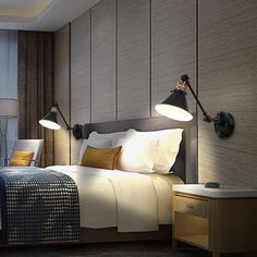 a hotel room with a bed and two lamps