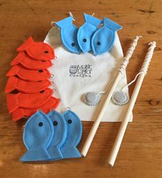 some felt animals are sitting next to toothbrushes on a wooden table with other items