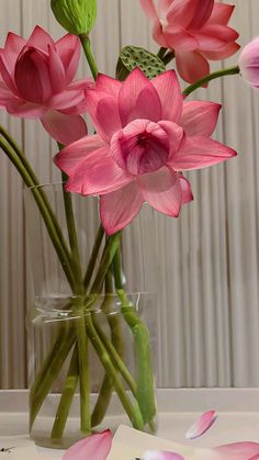 a vase filled with pink flowers on top of a table