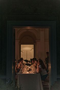 a group of people sitting around a dinner table