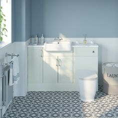 a bathroom with blue walls and white fixtures