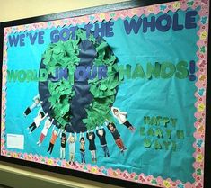 a bulletin board with children's hands and the words we've got the whole world in our hands