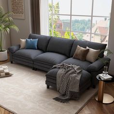 a living room with a couch, chair and rug on the floor in front of a large window