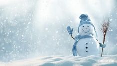 a snowman holding a broom standing in the snow