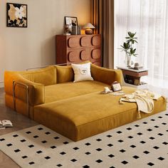 a living room with a large yellow couch in the center and a white rug on the floor