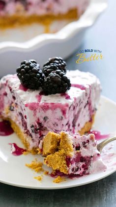 a piece of cheesecake on a plate with berries and blueberry toppings, ready to be eaten