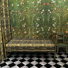 a room with a bench, chair and wallpaper