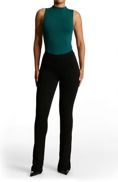 Sleek all-in-one style and breathable stretch jersey makes this thong bodysuit a svelte option for all your warm-weather plans. This form-fitting essential is made from the label's signature NW fabric, which is double lined, has four-way stretch, comfortable compression and a subtle crepe texture. Snap closure Funnel neck Sleeveless Lined 95% viscose, 5% elastane Hand wash, line dry Imported Casual High Waist Elastane Bodysuit, Casual High-waist Elastane Bodysuit, Stretch Bodysuit With Built-in Bra, Stretch Casual Bodysuit For Workwear, Stretch Seamless Tank Top For Night Out, Sleek Stretch Bodysuit For Spring, Basic Fitted Bottoms For Loungewear, Basic Fitted Loungewear Bottoms, Versatile Elastane Tank Top For Night Out