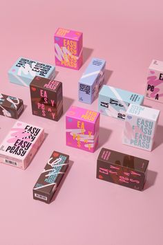 several different types of candy boxes on a pink surface with the words easy peas written across them