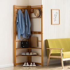 a room with a bench, coat rack and shoes on the floor next to it