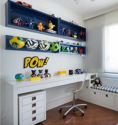 a white desk topped with shelves filled with toy figurines next to a window