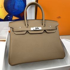 Description Hermes Birkin 30 Togo Etoupe Bag Silver Hardware For Women, Women’s Handbags 11.8in/30cm In 1984, somewhere above the English Channel on an Air France flight from Paris to London, the idea of the Birkin bag was born. As actress Jane Birkin star of ‘Wonderwall’ and ‘Blowup’ stuffed her trademark wicker basket bag into the overhead compartment, the contents spilled out onto the seat and aisle below. 30 x 22 x 16 cm / 11.8 x 8.6 x 6.3 inches (Length x Height x Width) Double rolled handl Paris To London, English Channel, Birkin 30, Hermes Birkin 30, Bag Silver, Jane Birkin, Air France, Wicker Basket, Basket Bag