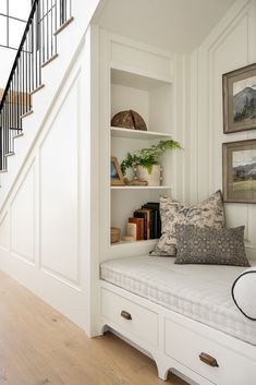 a white daybed sitting under a stair case