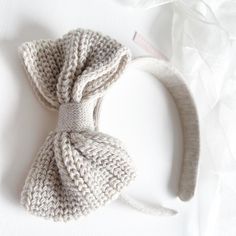 a crocheted headband with a knot on the side laying on a white surface