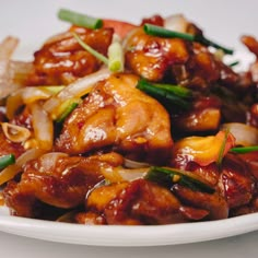 a white plate topped with meat and vegetables