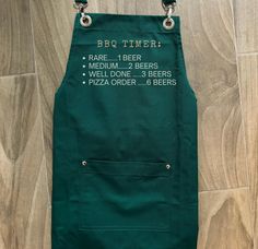 a green apron that says bbq timer on the front and bottom, with instructions for how to use it