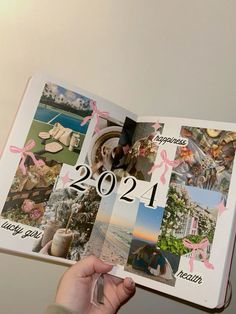 a person holding up a book with pictures on it and the words happy new year