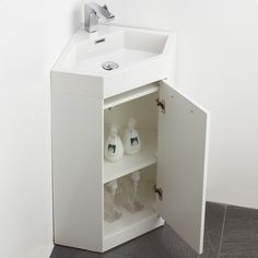 a white bathroom sink sitting under a mirror