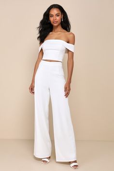 You'll only get more and more fabulous throughout the night while wearing the Lulus Exponentially Chic Ivory Off-the-Shoulder Two-Piece Jumpsuit! Stretchy crepe knit shapes this sensational two-piece jumpsuit that starts with an ultra-cropped top with a princess-seamed bodice and a folded-over, off-the-shoulder neckline (with hidden no-slip strips) that flows into short sleeves. The matching bottoms have a high, banded waist and wide pant legs that finish at full-length hems. An exposed silver z Elegant Fitted Off-shoulder Jumpsuits And Rompers, Elegant Strapless Jumpsuits And Rompers, Elegant Strapless Jumpsuits And Rompers For Gala, Elegant Strapless Jumpsuit For Gala, White Off-shoulder Evening Jumpsuits And Rompers, Elegant Off-shoulder Spring Sets, Elegant Off-shoulder Sets For Spring, White Off-shoulder Jumpsuits And Rompers For Evening, Elegant Fitted Sets For Date Night