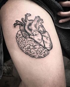 a heart and brain tattoo on the thigh