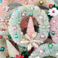 christmas wreaths and ornaments are arranged on display