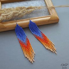 Colorful long seed beaded earrings, boho beaded earrings, shoulder dusters Handmade Orange Beaded Earrings For Summer, Handmade Orange Long Drop Earrings, Orange Handwoven Dangle Beaded Earrings, Orange Beaded Fringe Dangle Earrings, Adjustable Orange Beaded Fringe Earrings, Orange Dangle Tassel Earrings For Festival, Orange Bohemian Tassel Earrings With Dangling Beads, Bohemian Orange Beaded Earrings For Gifts, Orange Bohemian Jewelry With Beaded Fringe