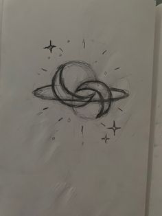 a drawing of an object in the air with stars around it on a piece of paper