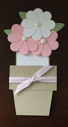 an open box with paper flowers on it