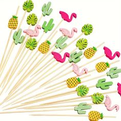 a bunch of pineapples and flamingos on sticks