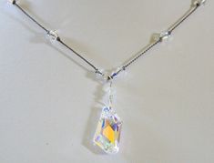 "Beautiful crystal AB Swarovski April birthstone necklace is hand knotted by me. Perfect gift for a April birthday or 15th anniversary gift for wife! I showcase the Crystal AB De-Art Pendant with Crystal AB Swarovski crystals handknotted on grey silk cord. The AB or aurora borealis is a fire polish on one side of the stone giving the effect of a rainbow of colors. The pictures don't do justice to the amount of sparkle these stones give off! Length is approximately 17.5\". Please contact me if yo Faceted Crystal Necklace As A Gift, Adjustable Faceted Crystal Necklace For Gifts, Adjustable Crystal Necklaces For Anniversary, Crystal Pendant Necklace Single Strand Gift, 15th Anniversary Gift, April Birthstone Necklace, April Birthday, Anniversary Gift For Wife, 15th Anniversary