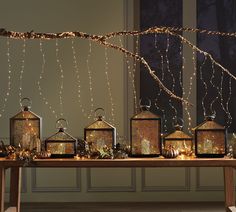 a table topped with lots of lanterns and lights