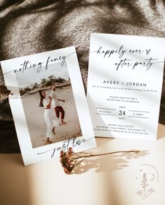 two wedding cards with the same photo on them, sitting next to an open book