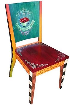 a colorful wooden chair with a bowl of fruit painted on the seat and back side