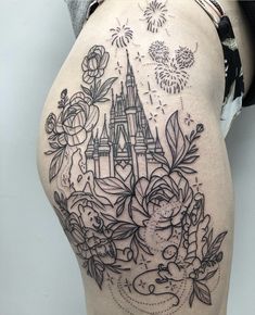 the back of a woman's thigh with an image of a castle and flowers on it