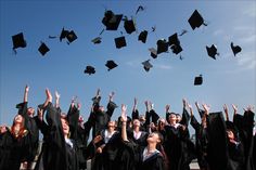 a group of graduates throwing their caps in the air