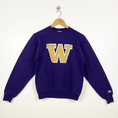 Vintage NCAA University of Washington 'Huskies' Sweatshirt Embroidery Logo Purple Color Men's XS - Made in Honduras Materials : Cotton, Polyester  - Tag Reads : XS Kindly see the actual measurements (All measurements were taken lying flat) - Actual size manual measurements * Width (Armpit to armpit) : 19 inches * Length (Shoulder to end of garment) : 23.5 inches * Sleeve length : 24 inches - Condition : * Good condition 8/10 (80%) * Minor stain refer picture * Free from tear and major defect - S Collegiate Long Sleeve T-shirt With Letter Embroidery, Varsity Long Sleeve T-shirt With Embroidered Logo, Winter Sports Tops With Embroidered Logo, Winter College Tops With Embroidered Logo, Collegiate Long Sleeve Sweatshirt With Embroidered Logo, Purple Winter College Tops, Purple Winter Tops For College, Crew Neck Top With Embroidered Logo For College, Collegiate Crew Neck Top With Embroidered Logo