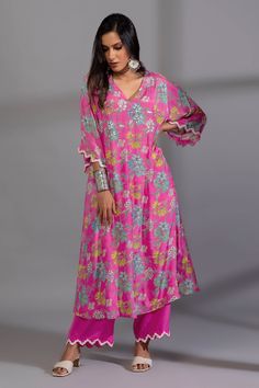 Rani pink kurta with botanical digital print and sequin embroidered sleeve hem. Paired with pant.
Components: 2
Pattern: Digital Printed, Embroidery
Type Of Work: Botanical, sequin
Neckline: V neck
Sleeve Type: Long sleeves
Fabric: Cotton Silk
Color: Pink
Other Details: 
Cutwork sleeve hem
Side pockets
Embroidery on pant hem
Length:
Kurta: 46 inches
Pant: 40 inches
Occasion: Mehendi and Haldi - Aza Fashions Pink Floral Print Festive Sets, Festive Pink Floral Print Sets, Pink Cotton V-neck Sets, Pink V-neck Cotton Sets, Pink Floral Print Loungewear Sets, Bohemian Pink Sets With Printed Motifs, Pink Sets With Printed Motifs For Spring, Festive Pink Printed Sets, Pink Spring Sets With Printed Motifs