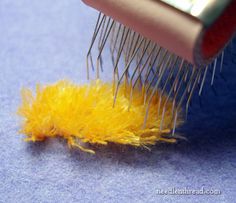 a close up of a brush with yellow feathers on it