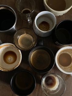 several cups of coffee sit on a table