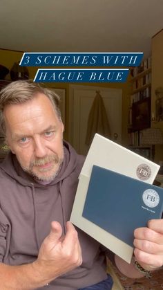 a man holding up a blue and white box