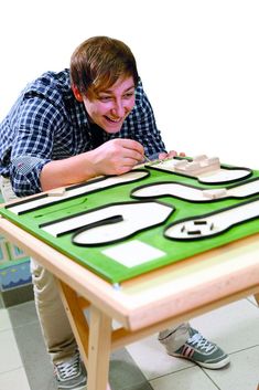 a young man is playing a game on the table