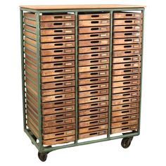 a large wooden crate with many drawers on wheels