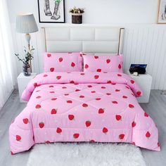 a pink bed with strawberry print on it